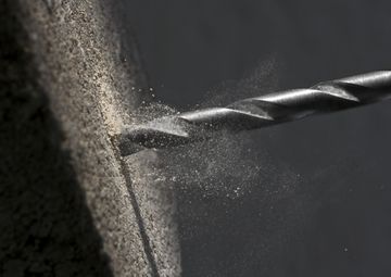 How do you drill concrete without producing dust?