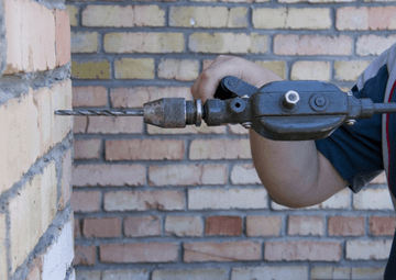 How do you drill a brick wall?